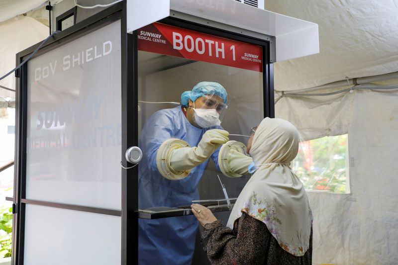 FILE PHOTO: A Medical worker collects a swab sample from