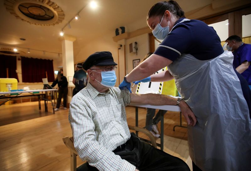 FILE PHOTO: A man receives a vaccine against the coronavirus