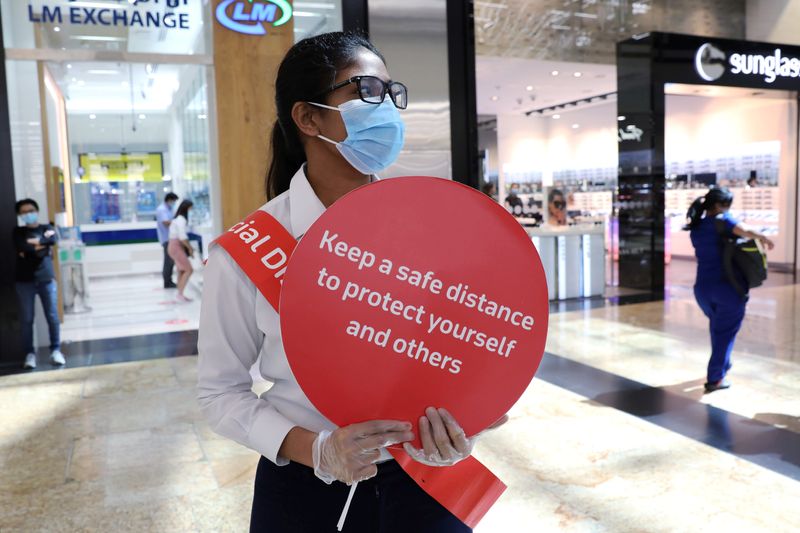 FILE PHOTO: A woman wearing a protective face mask and