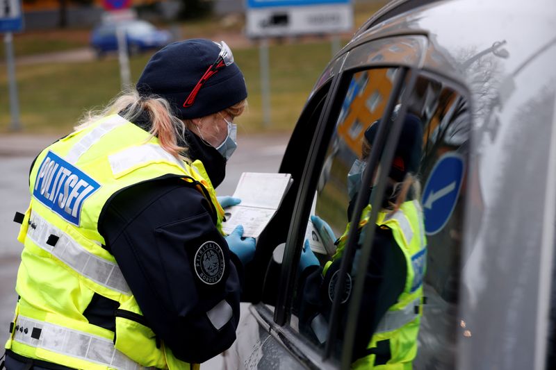 FILE PHOTO: Estonian police officer checks documents at the border