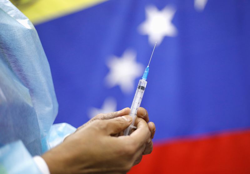FILE PHOTO: A Venezuelan health worker prepares to vaccinate a
