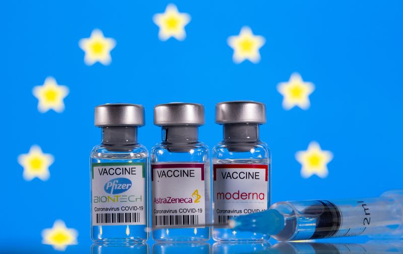FILE PHOTO: Picture illustration of vials with Pfizer-BioNTech, AstraZeneca, and