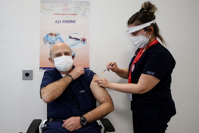 Ihsan Yavuz receives a shot of the Pfizer-BioNTech coronavirus disease