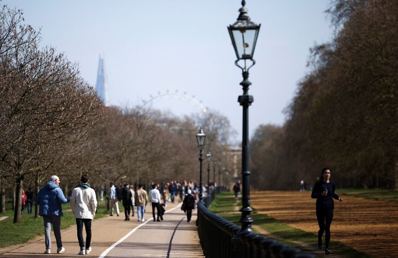 A woman jogs through Hyde Park, amid the coronavirus disease