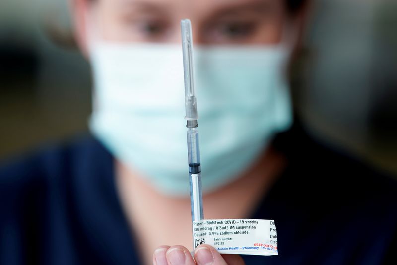 FILE PHOTO: The Pfizer COVID-19 vaccine is prepared by a