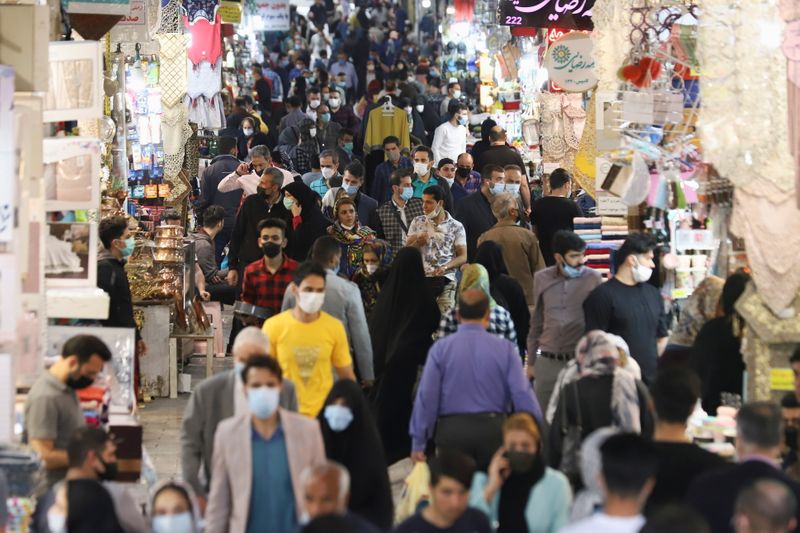 Iranian people walk in Tehran Bazaar, in Tehran