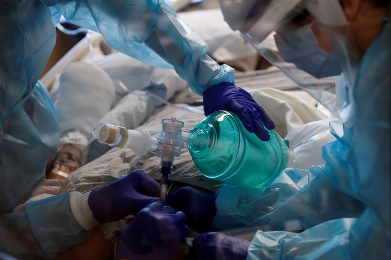 FILE PHOTO: Critical care workers insert an endotracheal tube into