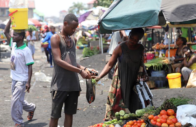FILE PHOTO: A Congolese man buys groceries at an open