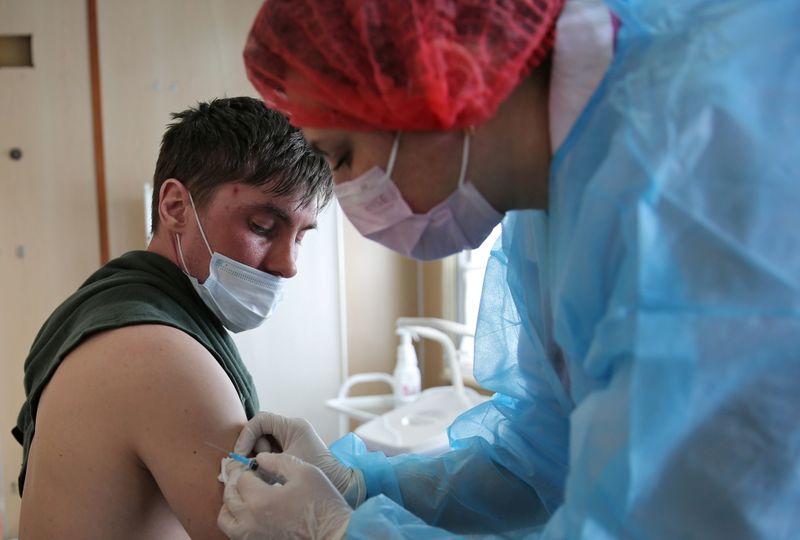 FILE PHOTO: A man receives a dose of COVID-19 vaccine