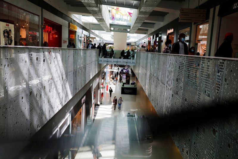 People are seen in a shopping mall on the first