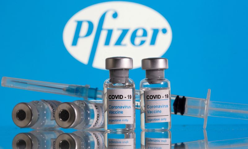 FILE PHOTO: Vials labelled “COVID-19 Coronavirus Vaccine” and a syringe