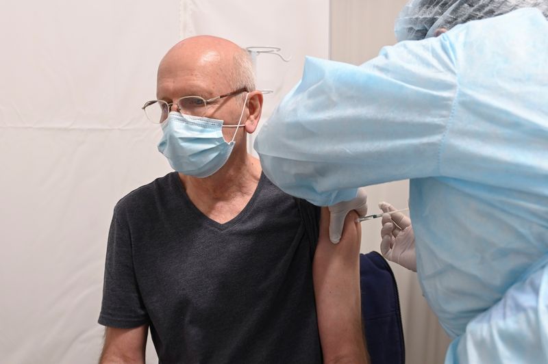 A man receives a vaccine against the coronavirus disease in