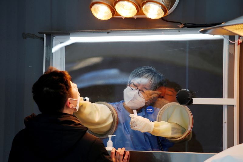 FILE PHOTO: A man undergoes the coronavirus disease (COVID-19) test