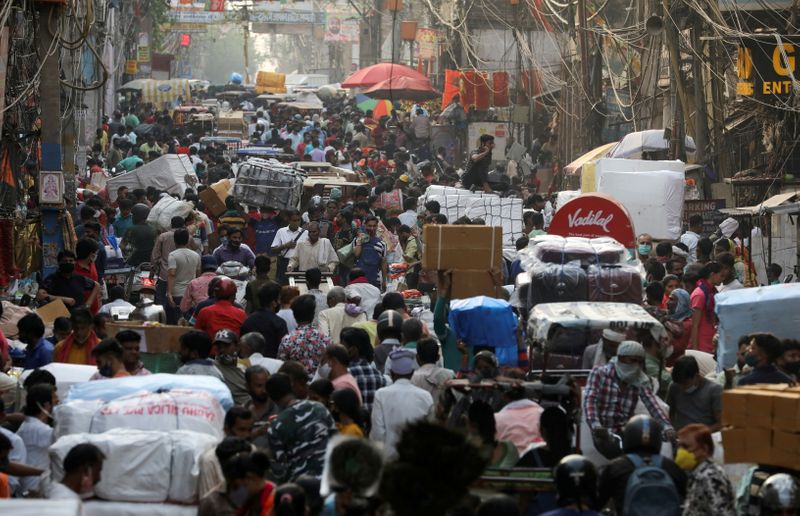 FILE PHOTO: People walk at a crowded market amidst the