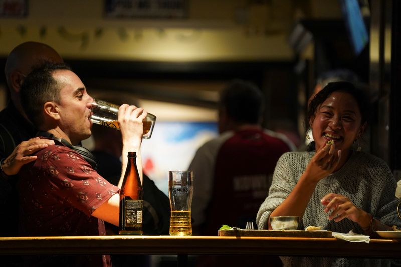 People drink at a bar in Hong Kong’s Lan Kwai