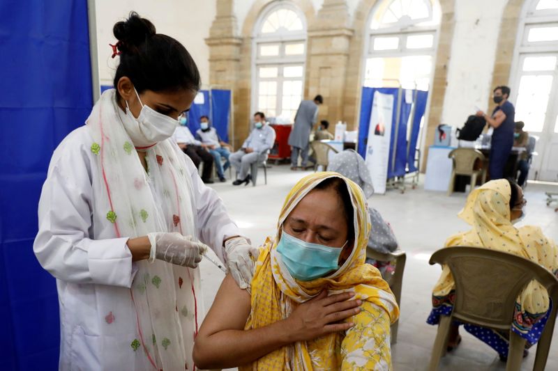 Residents receive COVID-19 vaccine in Karachi