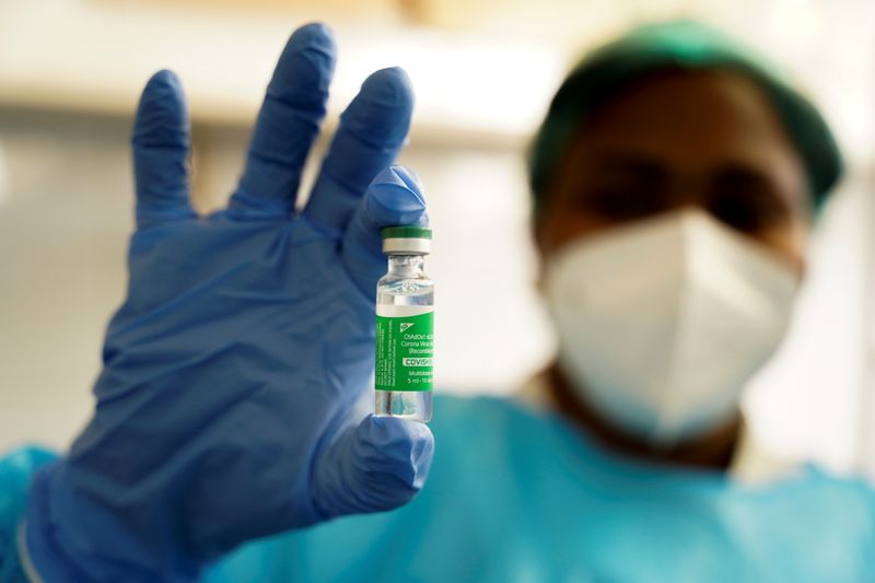 A nurse holds up a vial of the AstraZeneca coronavirus
