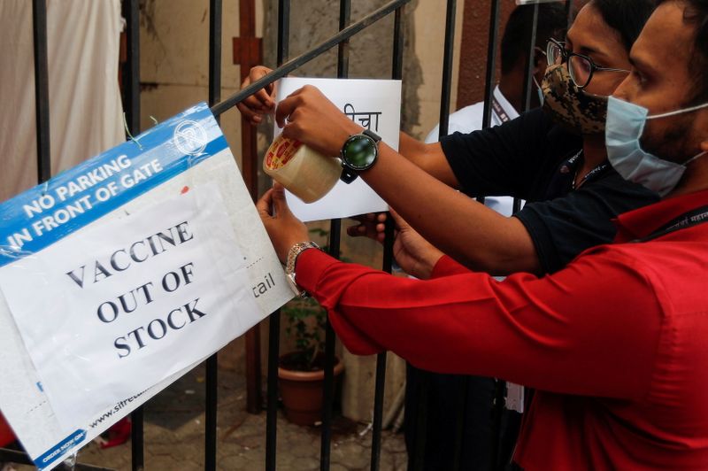 FILE PHOTO: Health workers attach a notice on the shortage