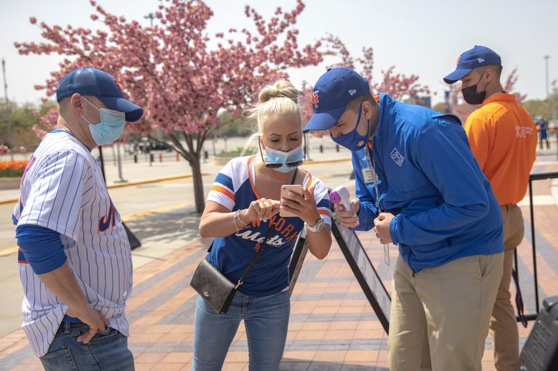 Fans arrive for a New York Mets game amid the
