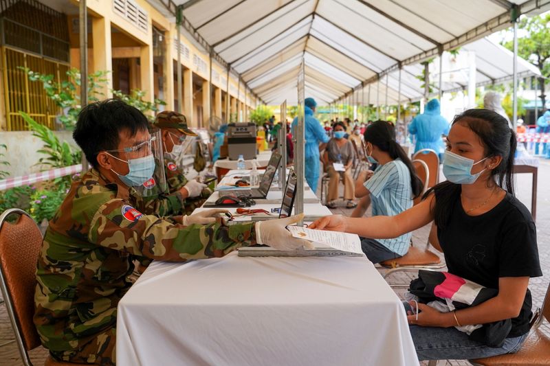 FILE PHOTO: Cambodian army members vaccinate people in Phnom Penh