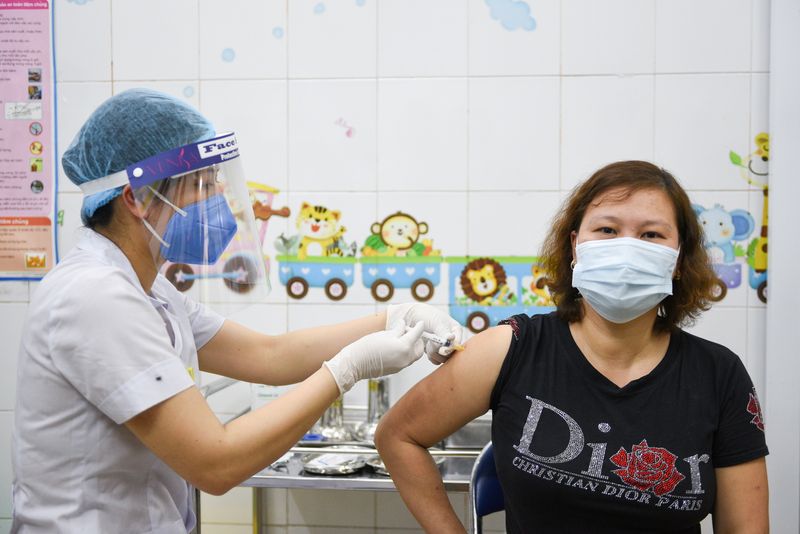 FILE PHOTO: A woman receives a vaccine as Vietnam starts