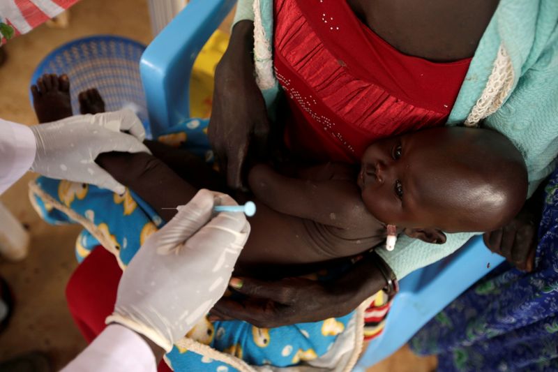 FILE PHOTO: A South Sudanese refugee child is vaccinated at