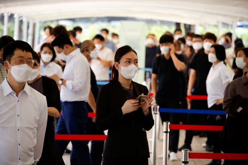 People wait in line to get coronavirus disease (COVID-19) test
