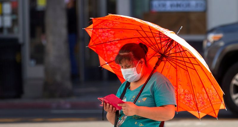 FILE PHOTO: A person wearing a protective face mask uses