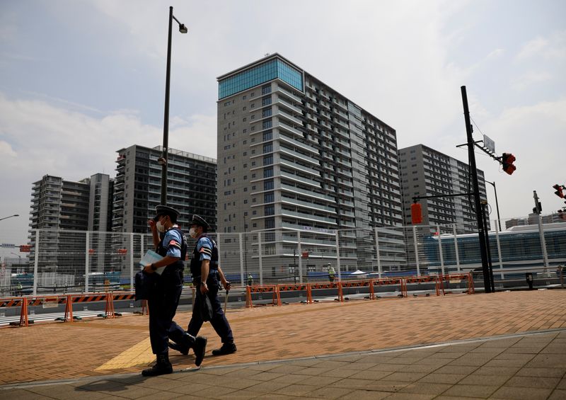 Police officers patrol outside the Athletes Village ahead of Tokyo