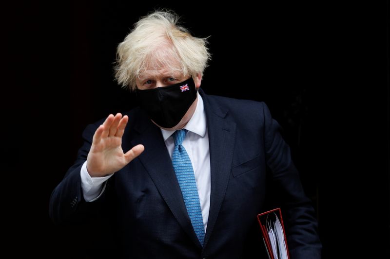 Britain’s PM Johnson walks on Downing Street in London