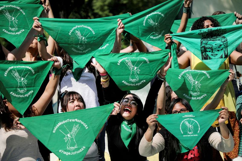 FILE PHOTO: Women hold green handkerchiefs during a protest in