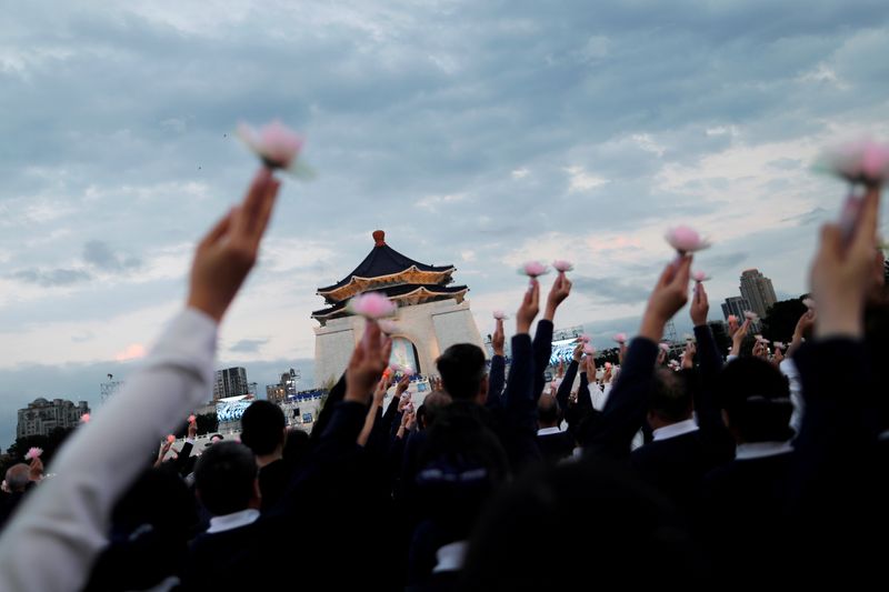 Members of the Buddhist Tzu Chi Foundation pray during a