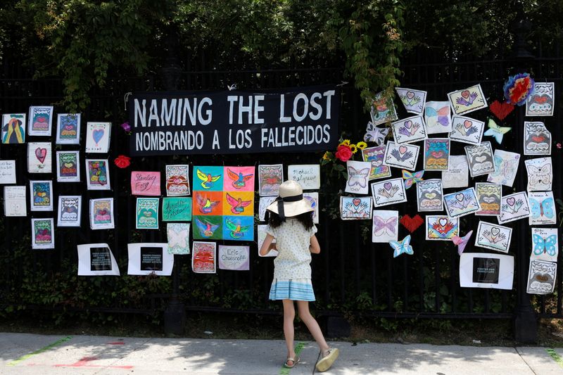 FILE PHOTO: A child looks at the “Naming the Lost