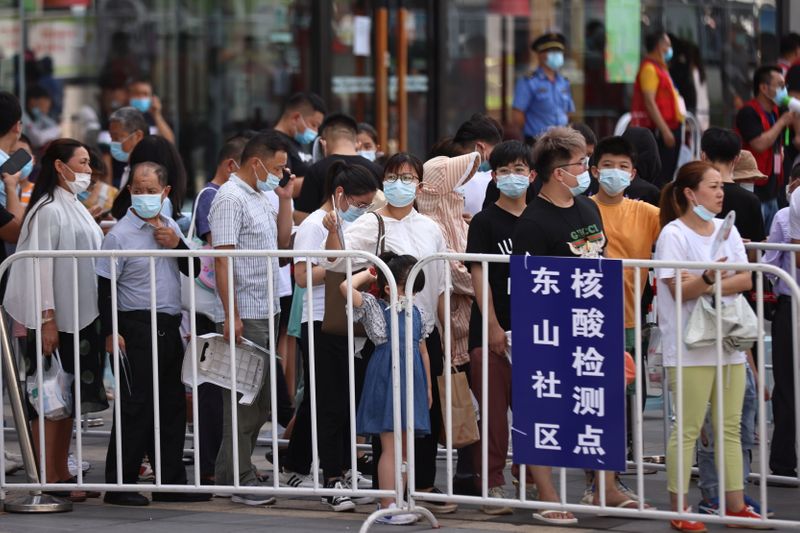People line up at a makeshift nucleic acid testing site