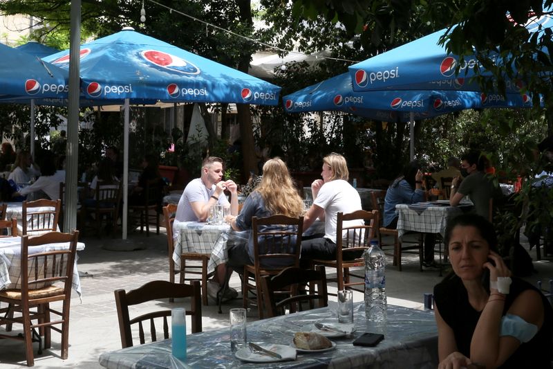 FILE PHOTO: Tourists eat at Monastiraki district in Athens