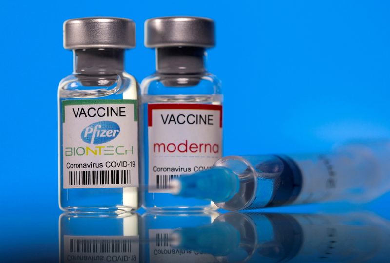 FILE PHOTO: Picture illustration of vials with Pfizer-BioNTech and Moderna