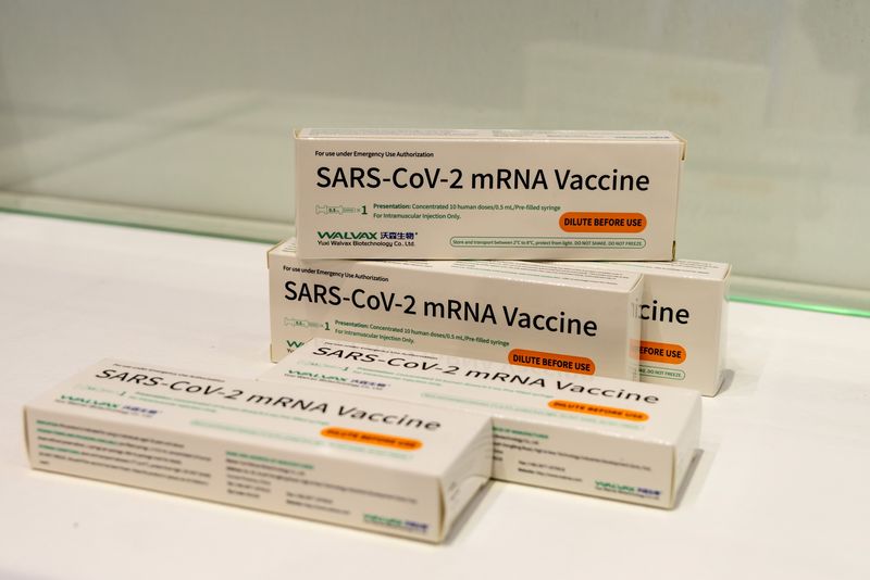 Boxes of Walvax Biotechnology’s mRNA COVID-19 vaccine are displayed at