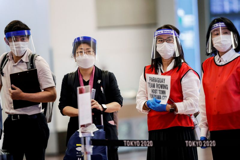 FILE PHOTO: Staff wearing face masks and shields wait for