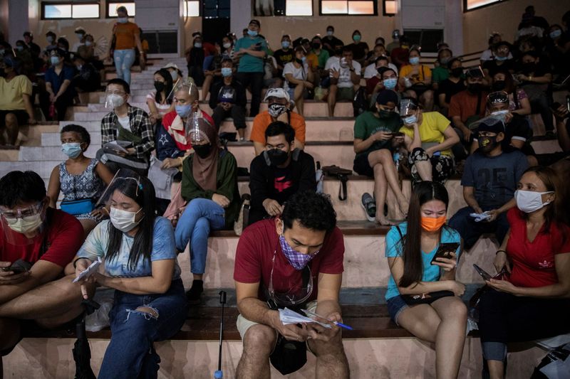 Filipinos queue for vaccination against the coronavirus disease (COVID-19) in
