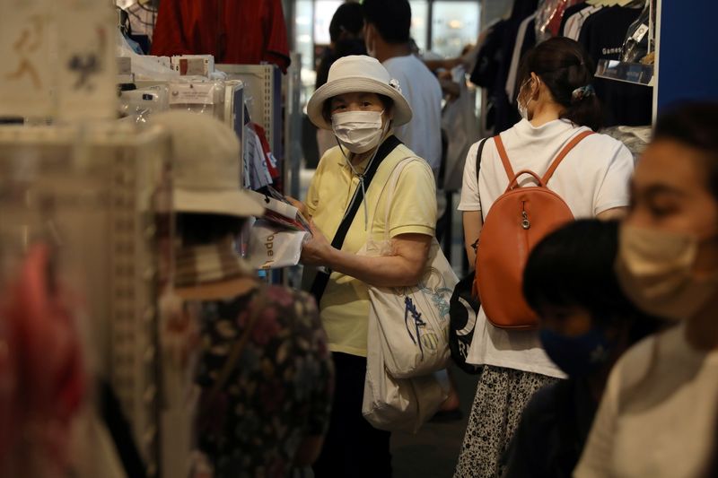 People shop in an official Olympics store amid the coronavirus
