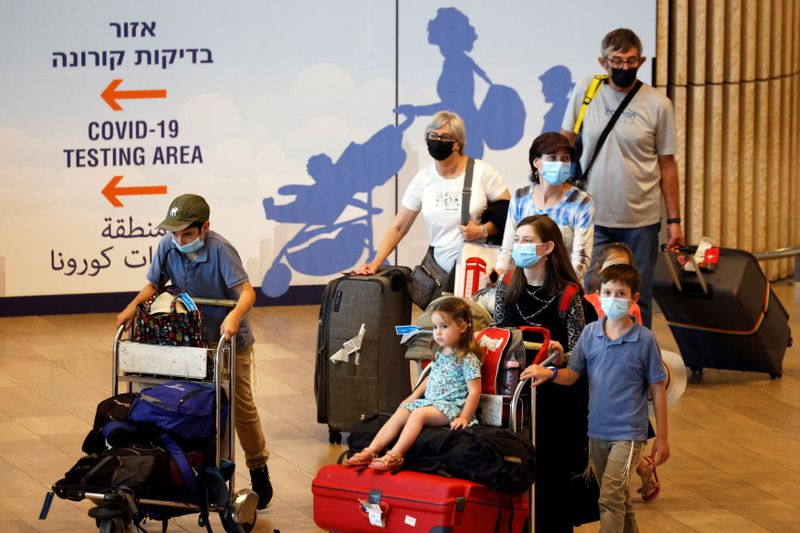 Travellers carry their luggage at the arrivals terminal in Israel’s