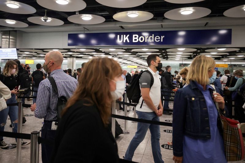 FILE PHOTO: FILE PHOTO: Arriving passengers queue at UK Border
