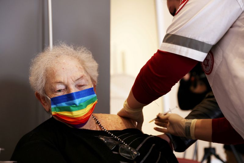FILE PHOTO: An elderly woman receives a booster shot of