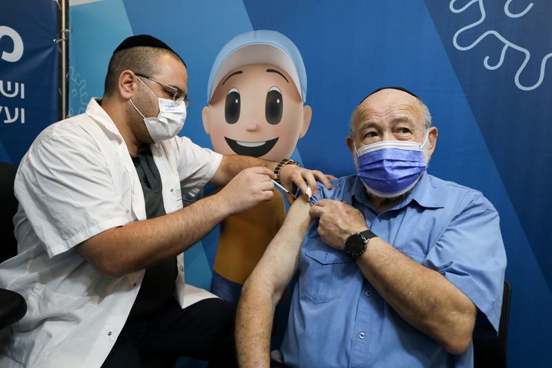 A man receives his third dose of the coronavirus disease