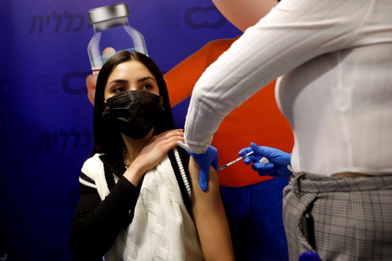 FILE PHOTO: A woman receives a vaccination against the coronavirus