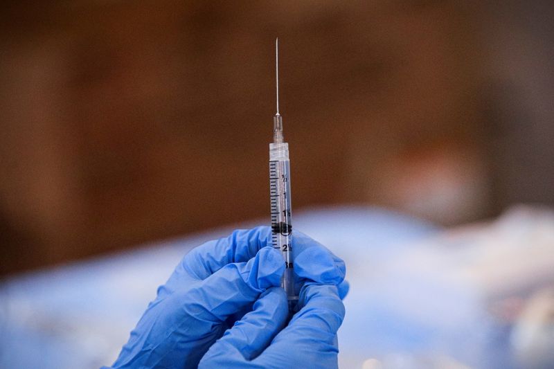 FILE PHOTO: A syringe is filled with a dose of