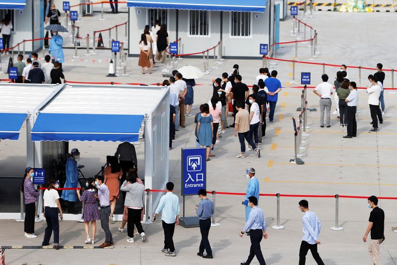 Staff members of Shanghai Pudong International Airport line up for