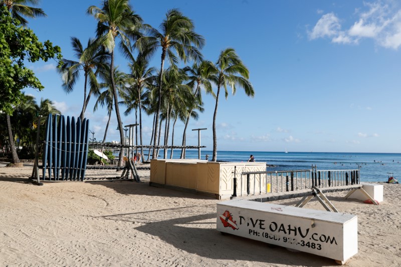 A surfboard concession stand is closed on Waikiki Beach due