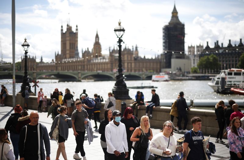 FILE PHOTO: People walk along the South Bank, amid the