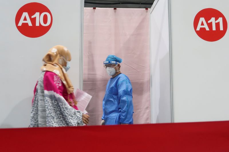 A woman enters a booth to get a coronavirus disease
